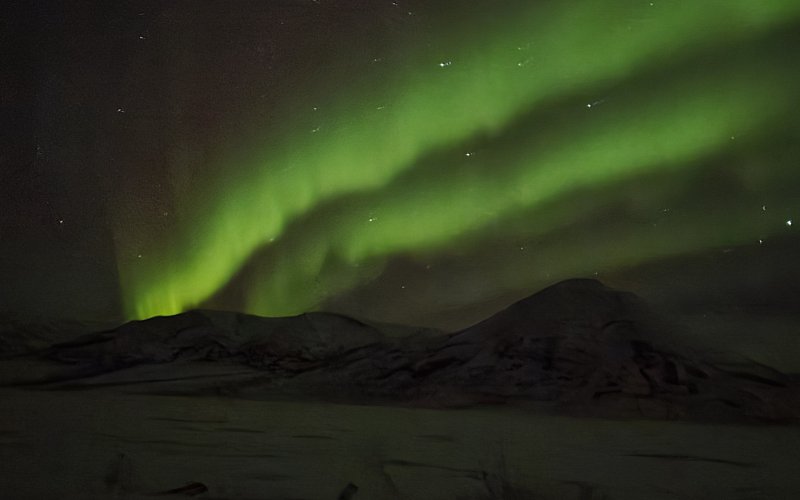 The Northern Lights above Mountains