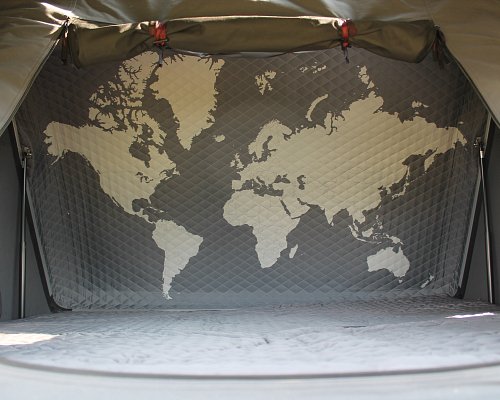 Interior of a rooftop tent with mattress and world map design, part of a Denali Backroads Overlander camping setup in Alaska.
