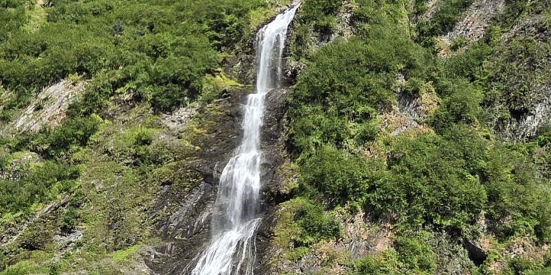 Camping under the Midnight Sun with waterfalls mountains and wildflowers during a Denali Backroads Overlander adventure
